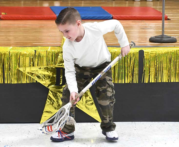boy playing lacrosse