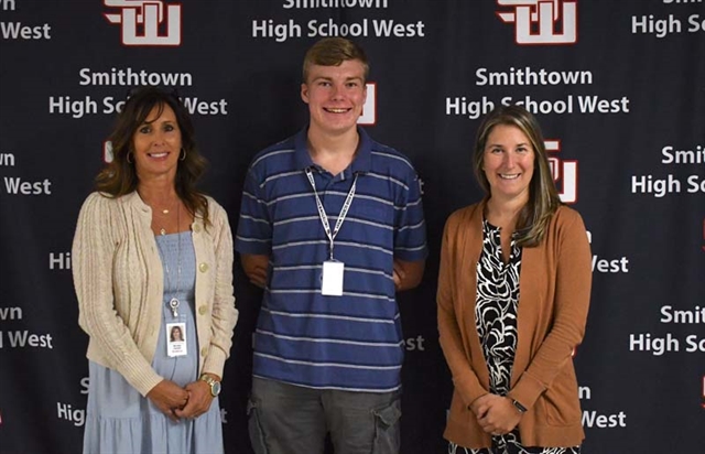 Daniel Davidsen posing for picture with AP and guidance counselor