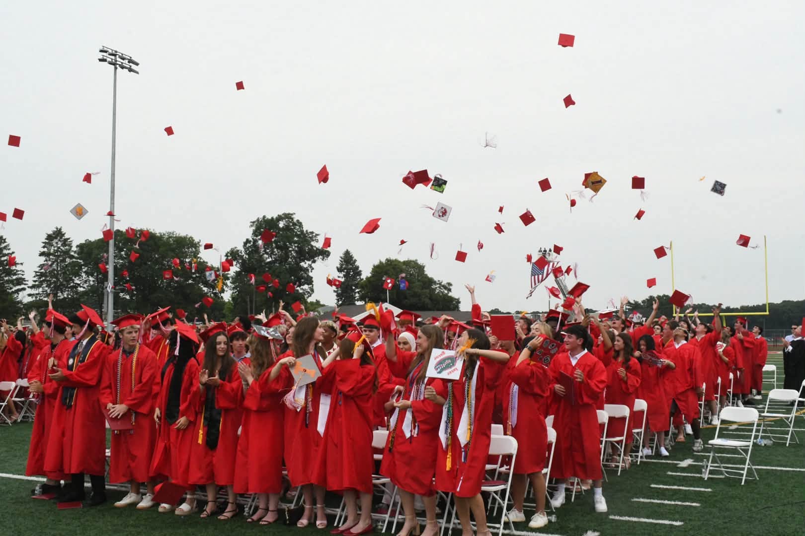 Graduation caps in air
