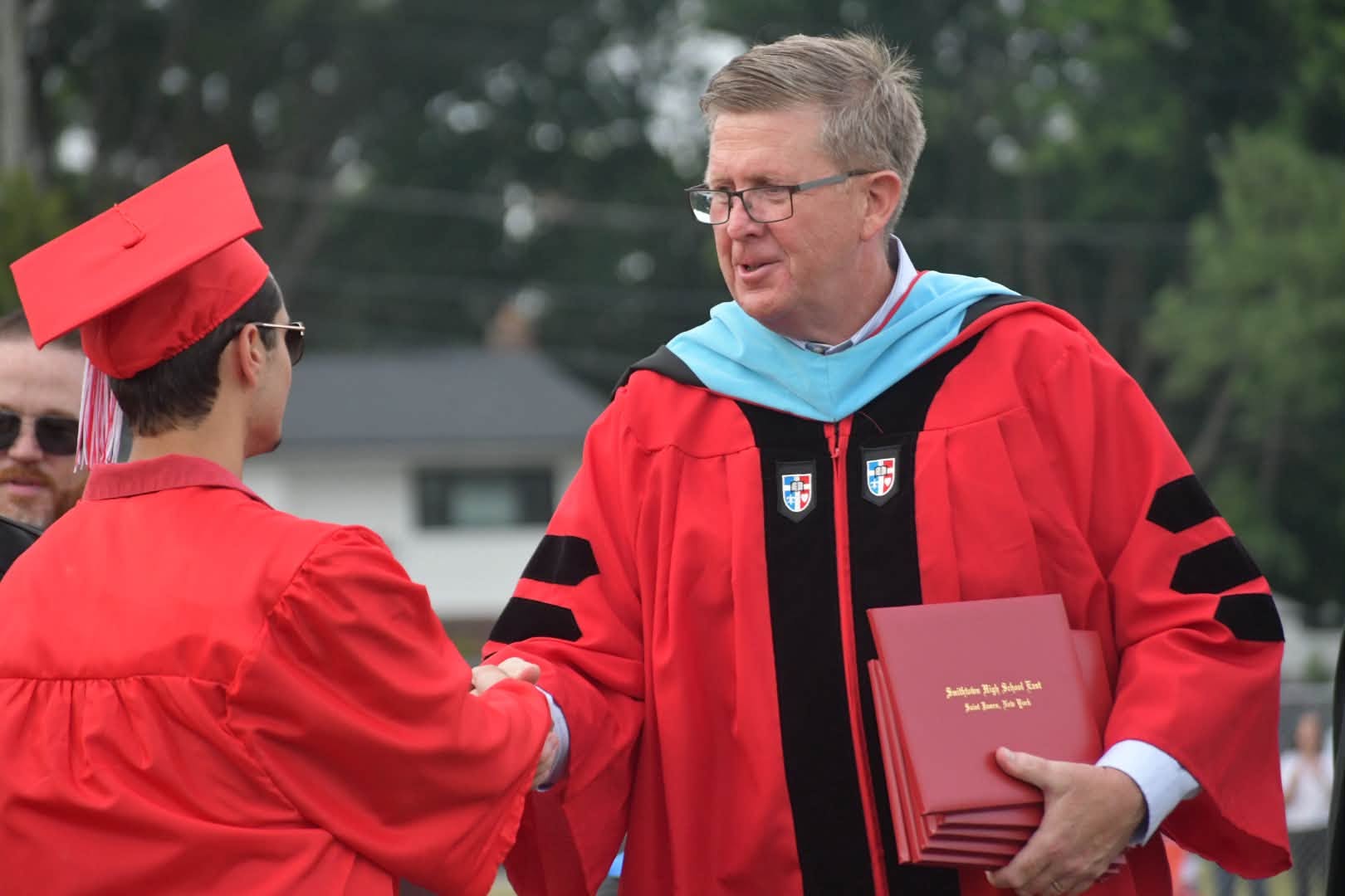 Dr. Secaur shaking hands