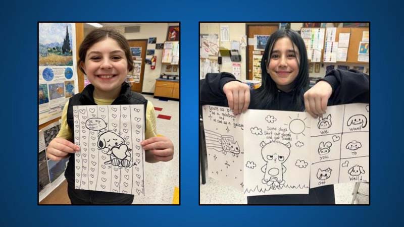 students posing with artwork