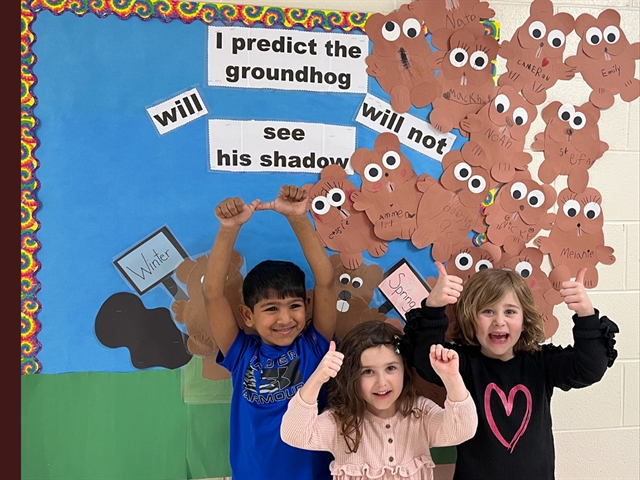 Students by groundhog signs