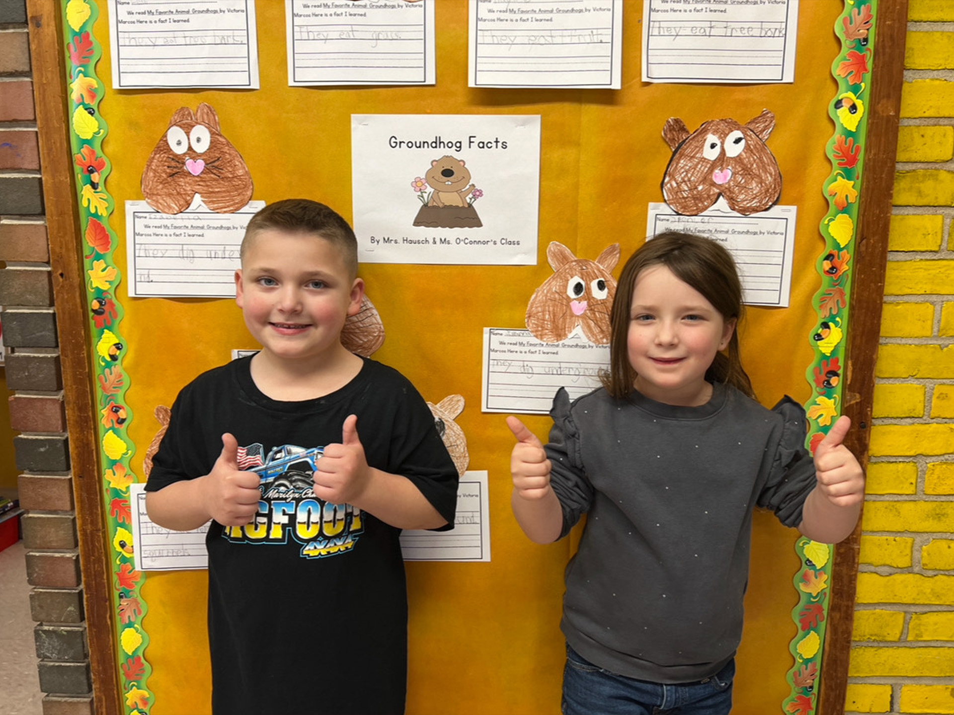 Students by groundhog sign