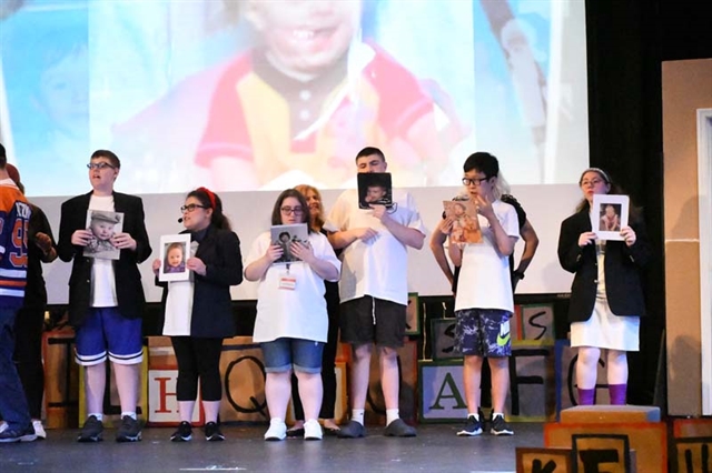 students performing on stage