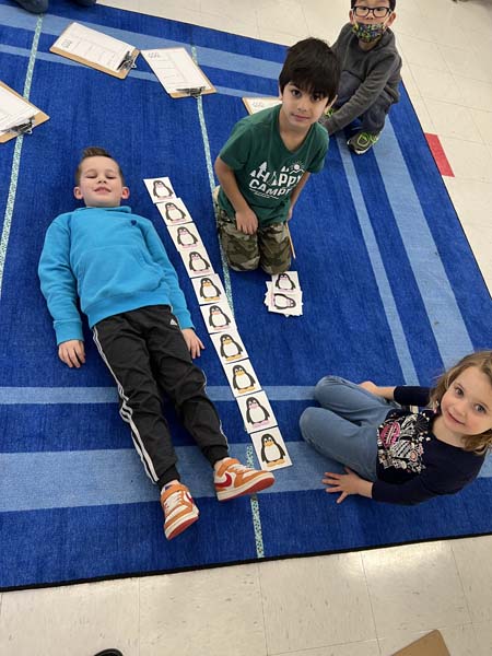 kids measuring themselves in class