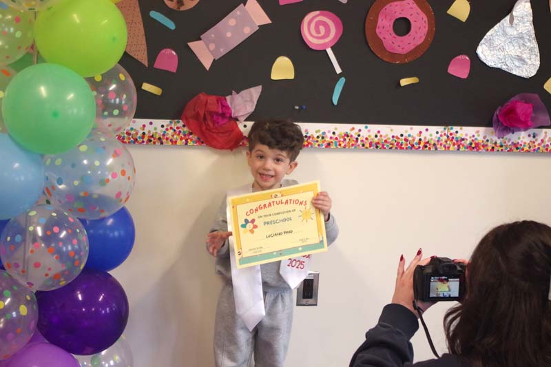 Student holding certificate