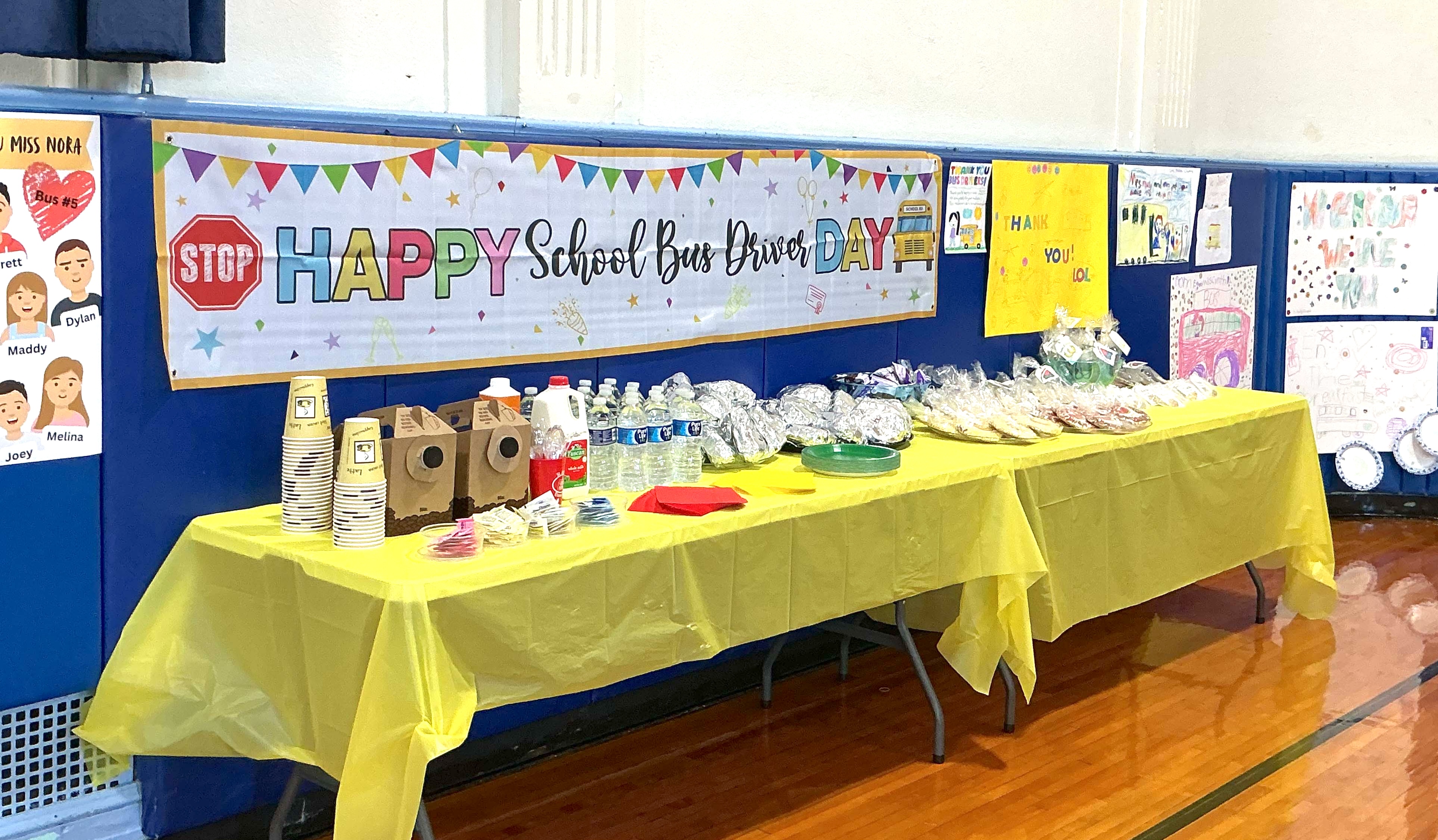a table with a sign saying happy school bus day