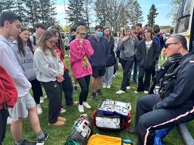 students watching helicopter