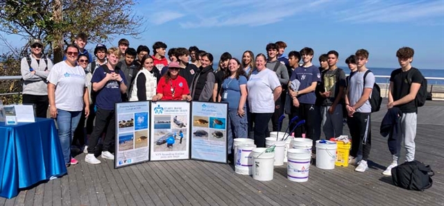 Students smiling for picture at beach