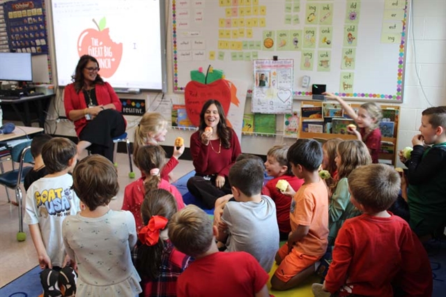 students in class with apples