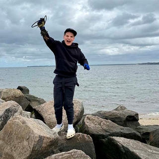 student on rock cheering