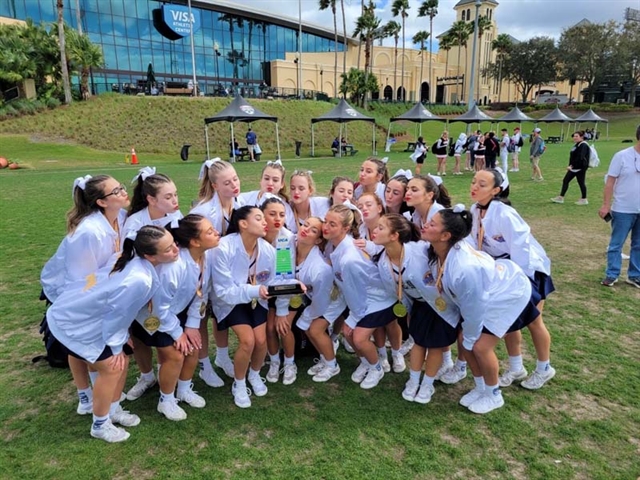 girls posing with trophy