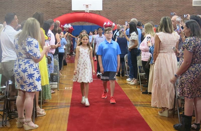 students walking from stage