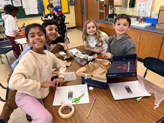 students smiling at table
