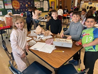 students smiling at table