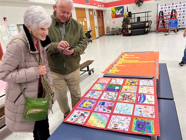 Family looking at history project