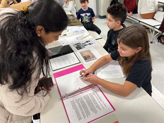 Family looking at history project