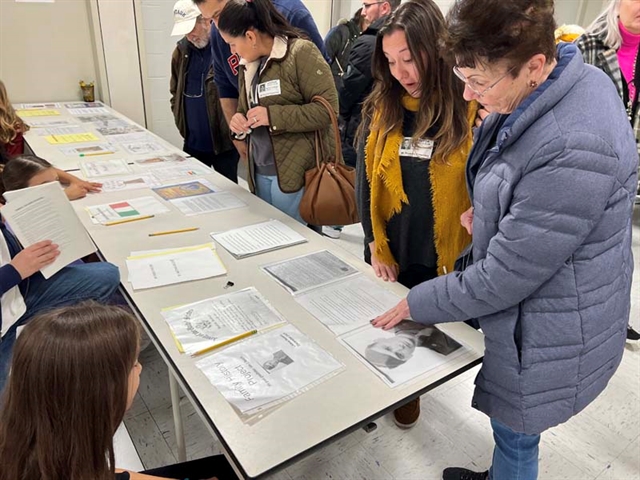 Family looking at history project