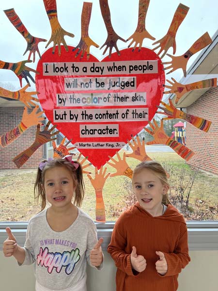 students smiling by MLK quotes