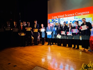 student holding award