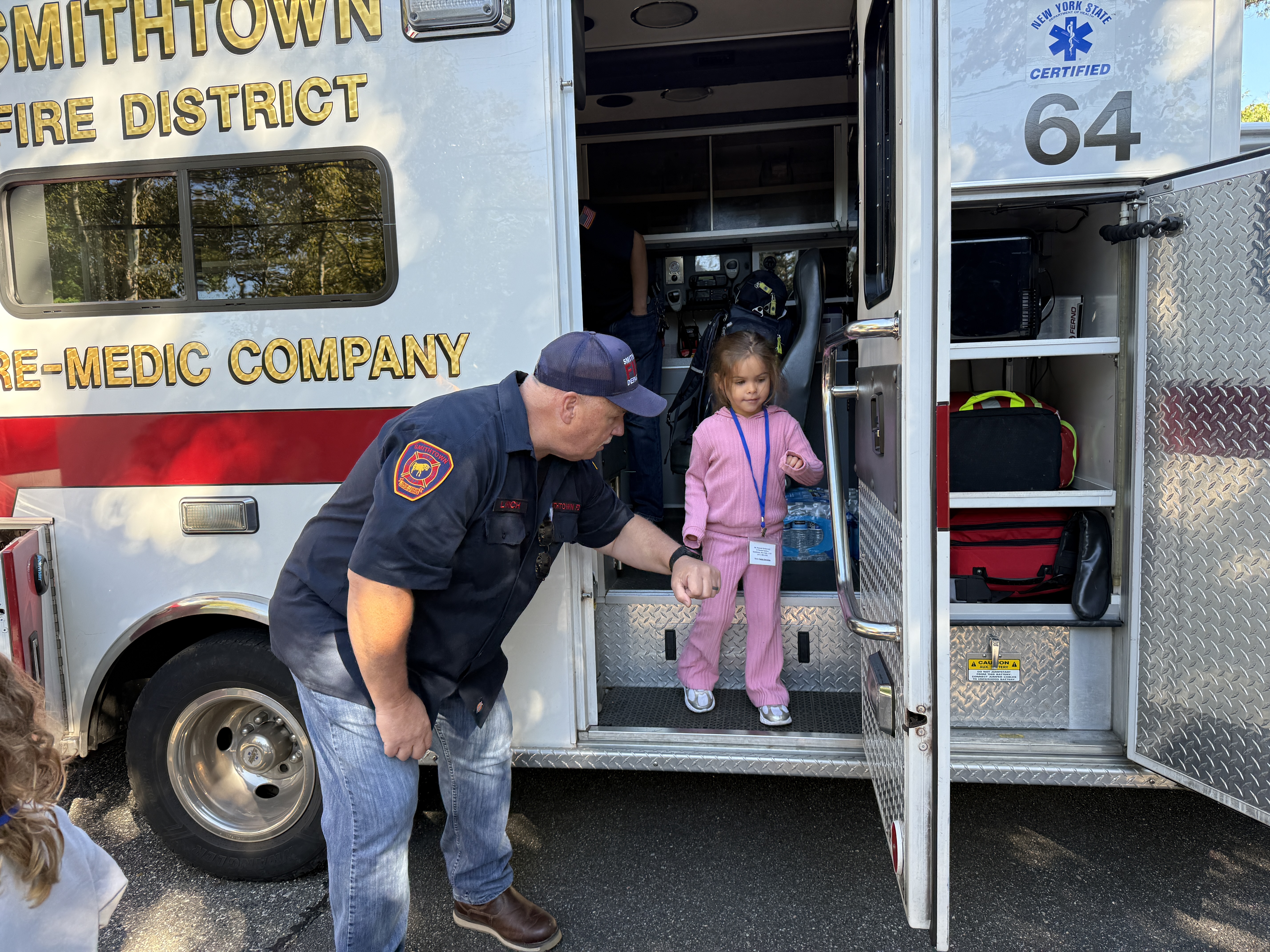 a firefighter helping a student