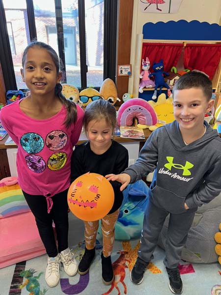 students smiling with balloons