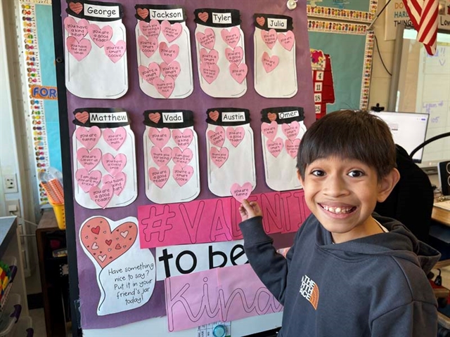 student smiling by picture