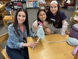 students and teacher crocheting