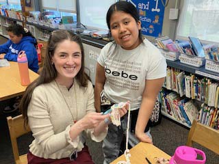 students and teacher crocheting