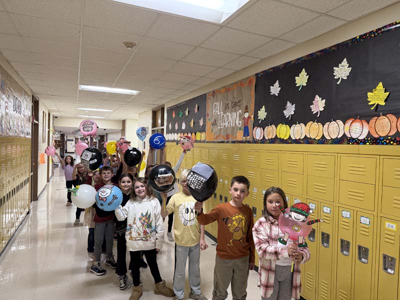 Students with balloons in hallways