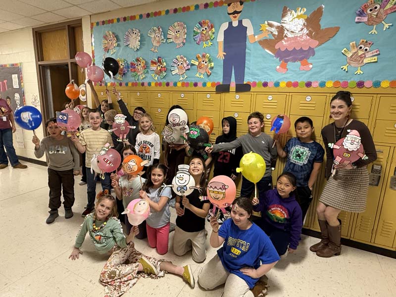 children holding balloons