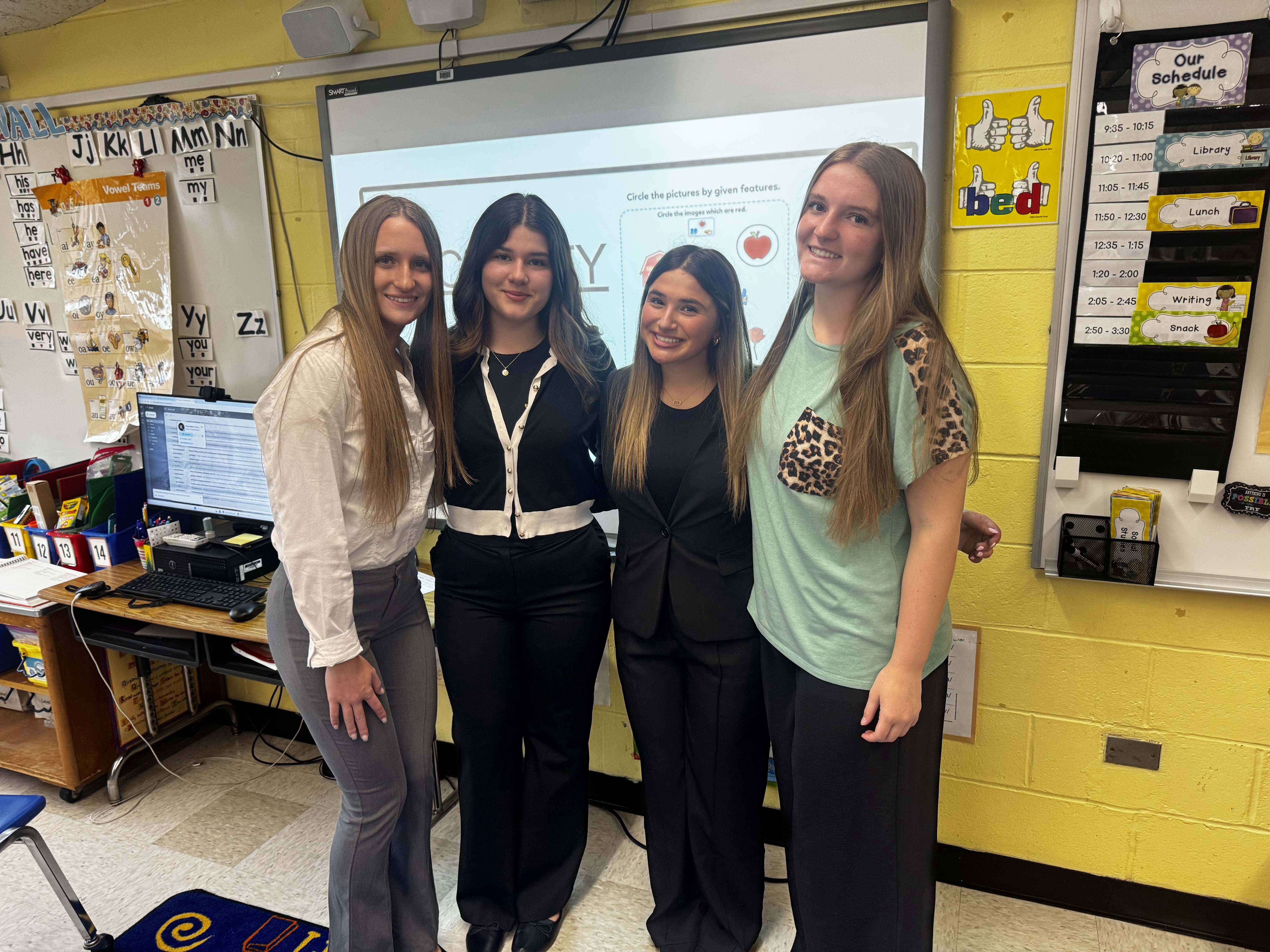 students and teacher smiling
