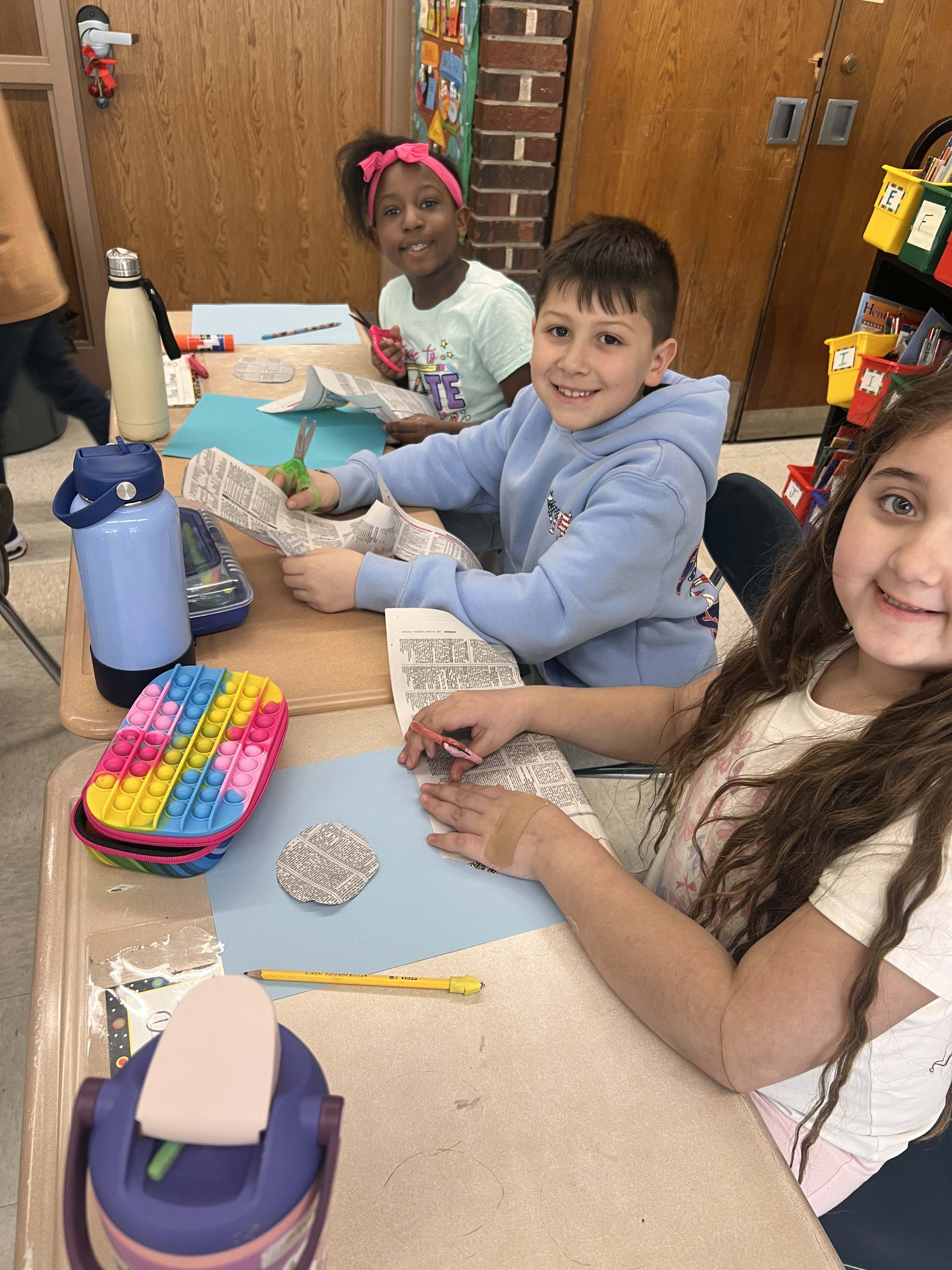 Students holding artwork