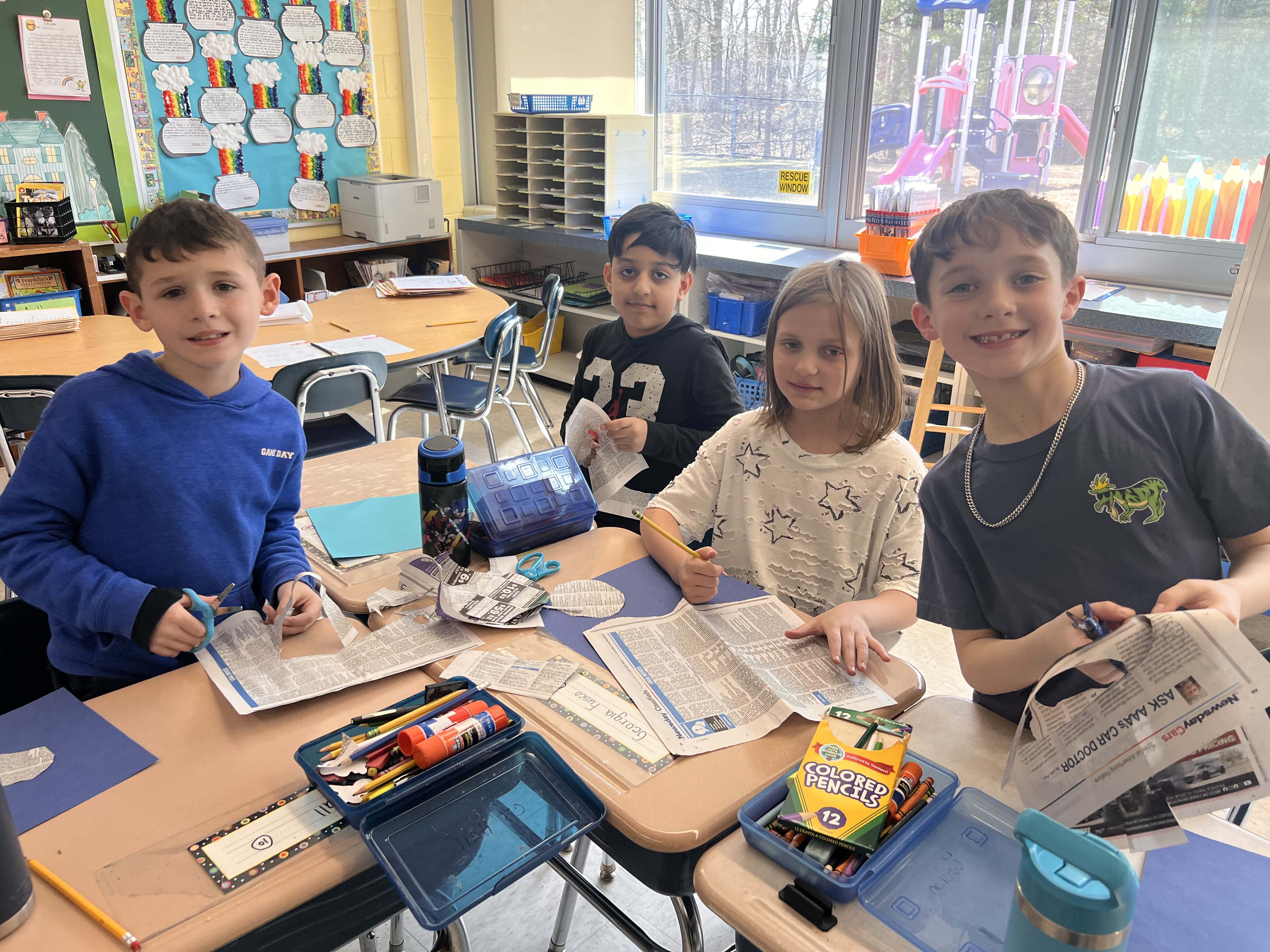 Students holding artwork