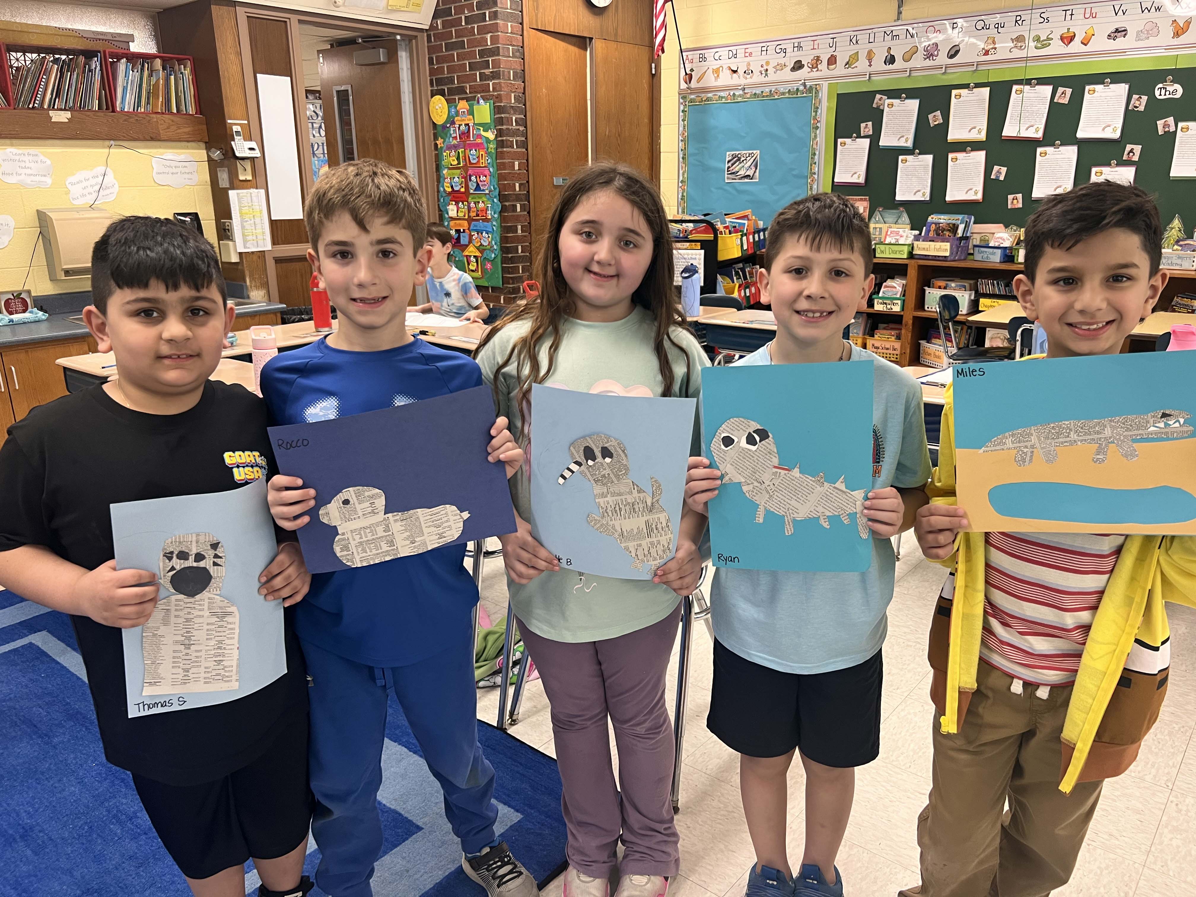 Students holding artwork