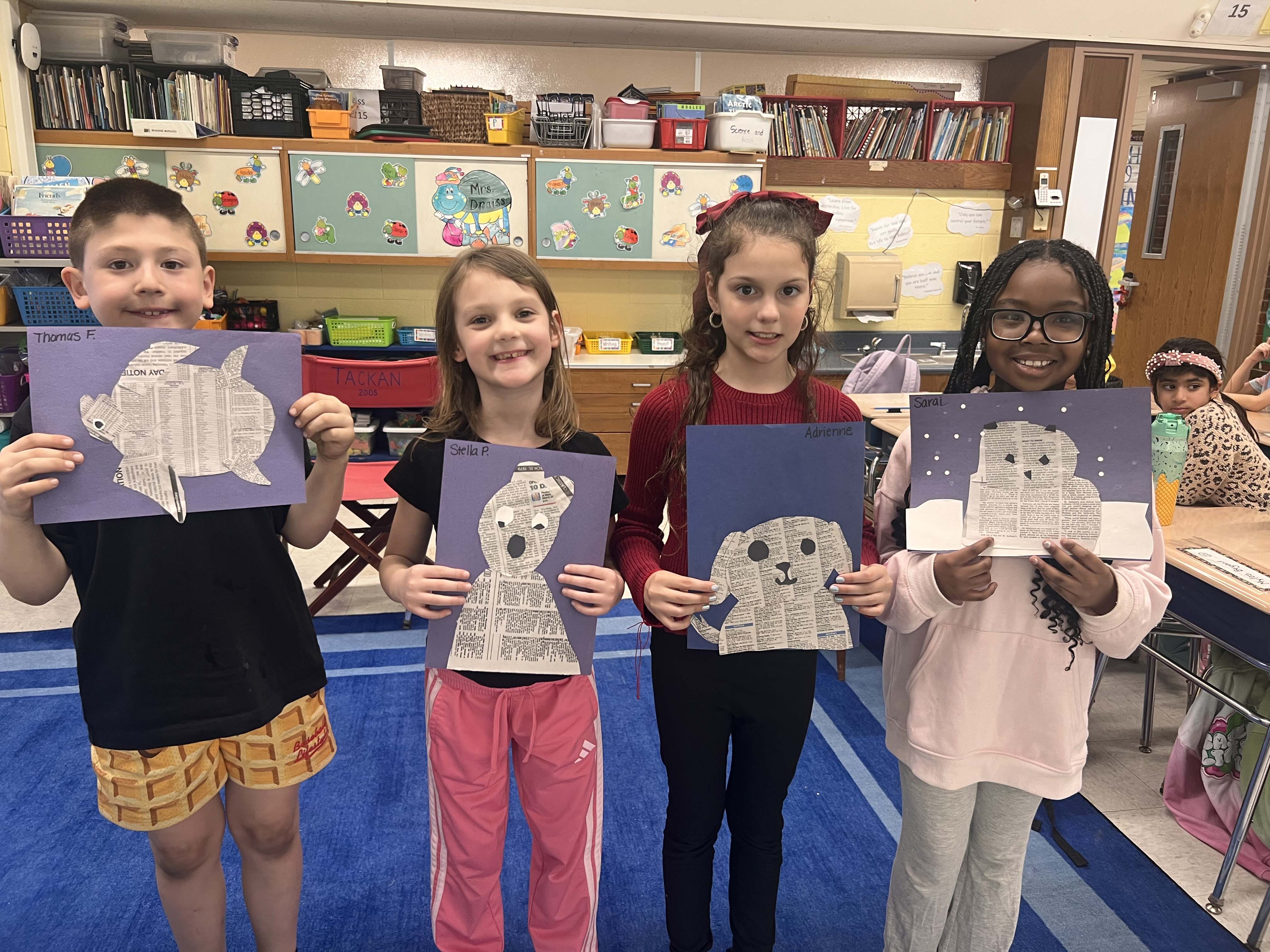 Students holding artwork