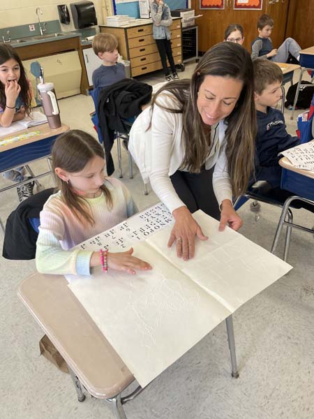 Principal Kakalos helping a student