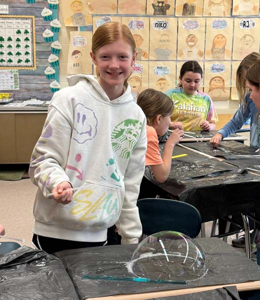 student posing with bubbles