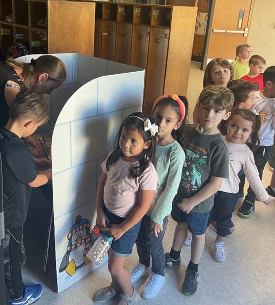 students in line waiting to vote