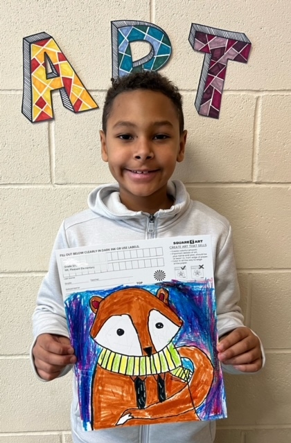 Student holding artwork