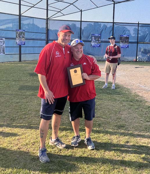 Coach Roper holding trophy