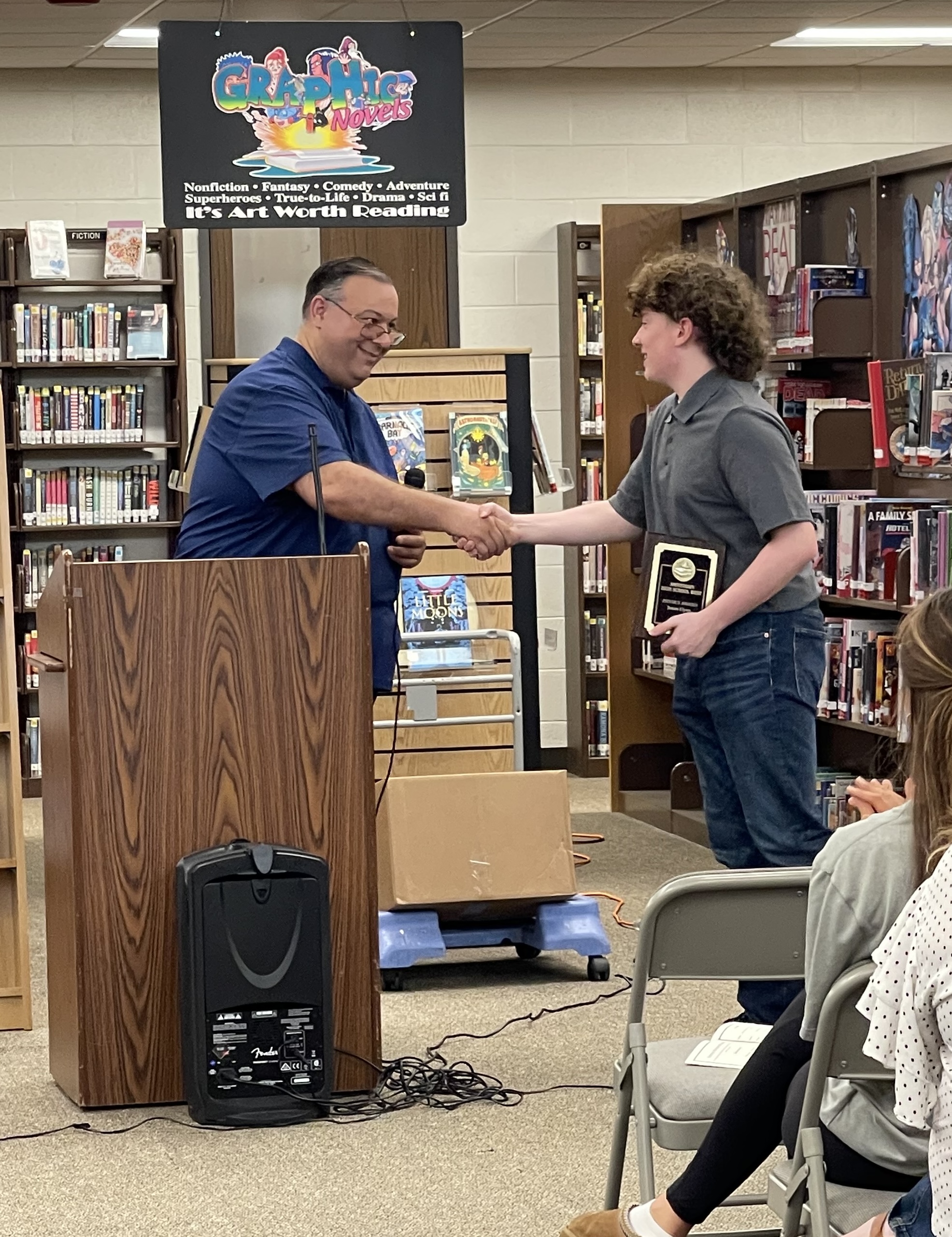 Student receiving award