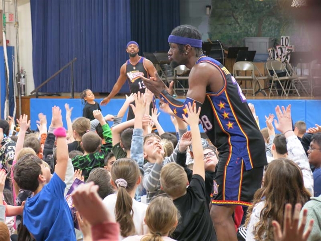 Harlem Wizards with students
