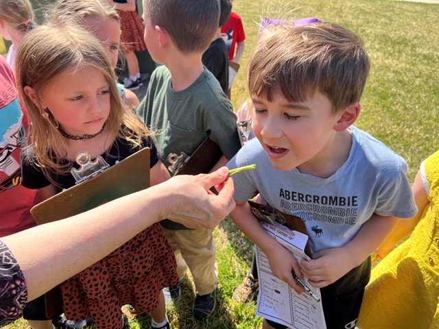 students smelling scallions