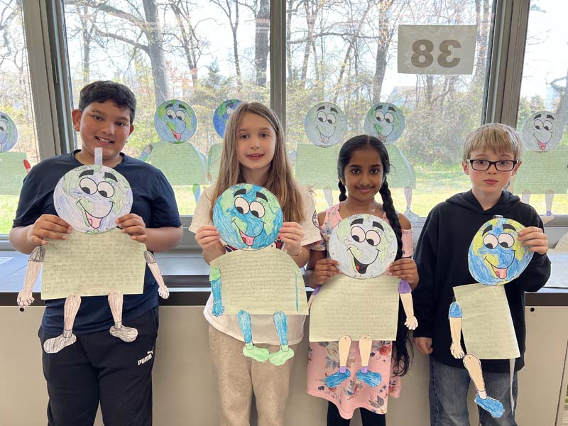 students holding up earth day signs