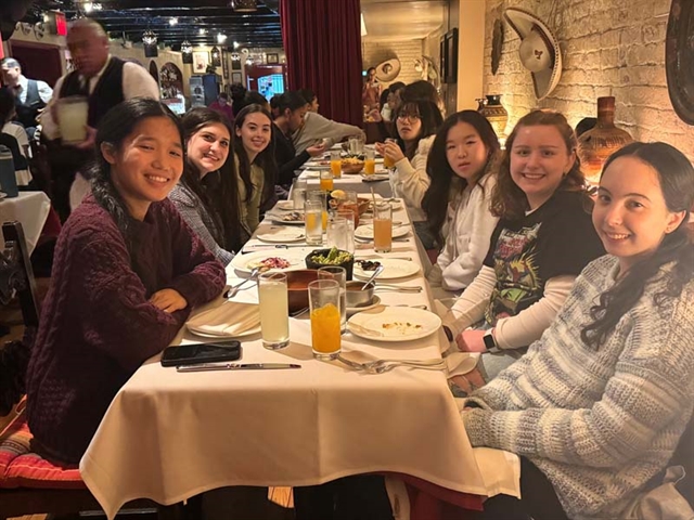 Students smiling for group photo in NYC