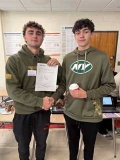 students smiling and shaking hands