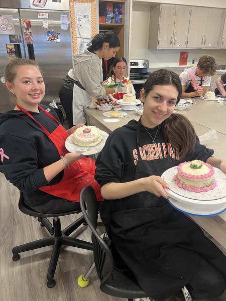 Student holding cake