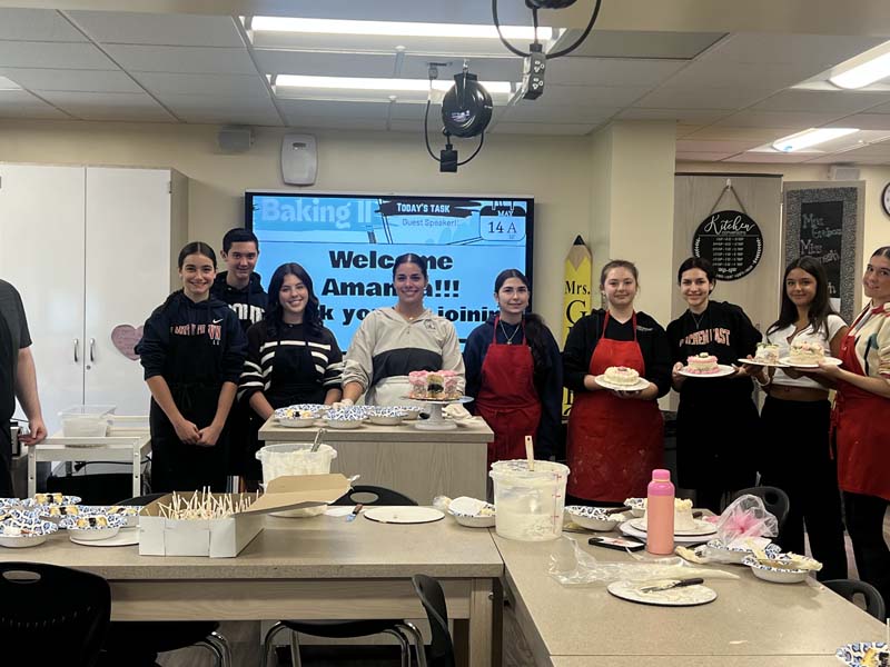 Students holding cake
