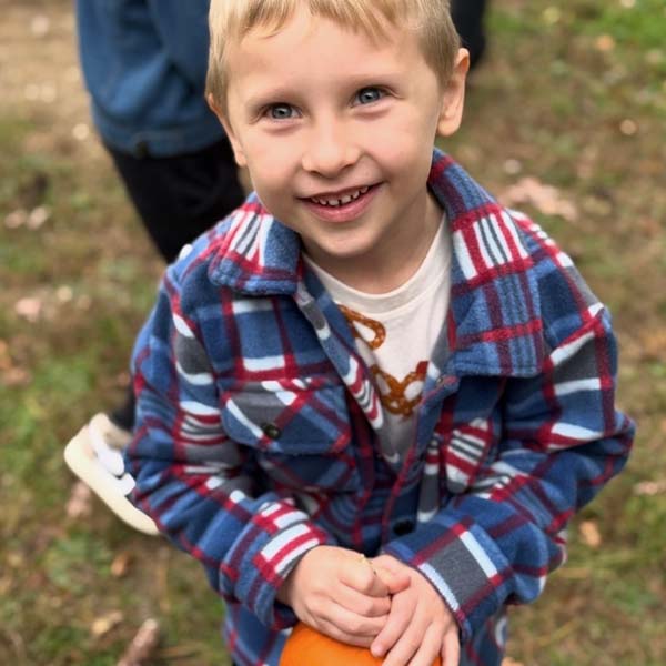 Student holding pumpkin
